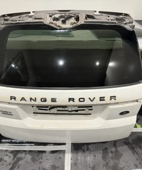 Range Rover tailgate with the rear window glass on a workbench for polishing