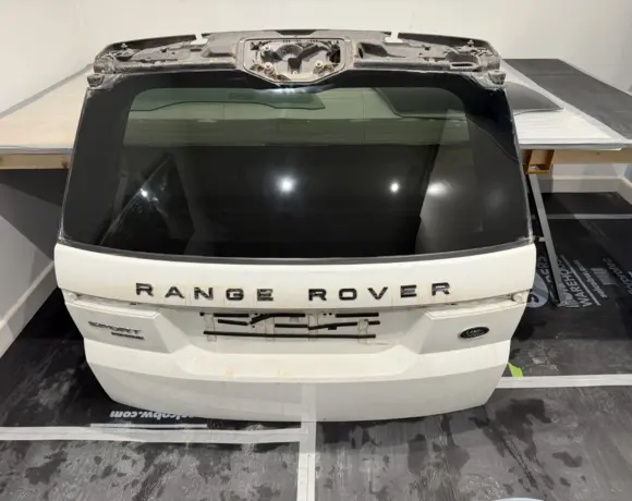 Range Rover tailgate with the rear window glass on a workbench for polishing